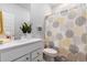 Clean bathroom with a white vanity, shower curtain with round design, and decorative plant at 179 Empyrean Circle, Myrtle Beach, SC 29588