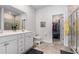 En suite bathroom featuring a double sink vanity, tile floors, and a walk-in closet at 179 Empyrean Circle, Myrtle Beach, SC 29588