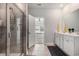 En suite bath with double vanity, tile floors, and seamless glass shower at 179 Empyrean Circle, Myrtle Beach, SC 29588