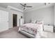 This bright bedroom features neutral carpet, a ceiling fan, and a walk-in closet at 179 Empyrean Circle, Myrtle Beach, SC 29588