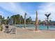 Relaxing community pool with mature palm trees, comfortable lounge chairs, and clear blue water at 179 Empyrean Circle, Myrtle Beach, SC 29588