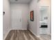 Entryway with grey wood floors, white door and an open view to a bedroom at 179 Empyrean Circle, Myrtle Beach, SC 29588