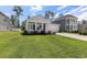 Charming single-story home with a well-manicured lawn, and an attached garage at 179 Empyrean Circle, Myrtle Beach, SC 29588