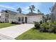 Charming single-story home with a well-manicured lawn and a two-car garage at 179 Empyrean Circle, Myrtle Beach, SC 29588