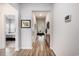Bright hallway featuring wood floors, white walls, and an open view into the comfortable living room at 179 Empyrean Circle, Myrtle Beach, SC 29588