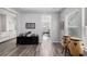 Open living space with wood floors transitions into a kitchen and sitting area at 179 Empyrean Circle, Myrtle Beach, SC 29588
