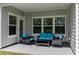 Covered patio with wicker furniture and plush turquoise cushions for ultimate relaxation at 179 Empyrean Circle, Myrtle Beach, SC 29588