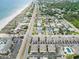 Wide aerial perspective showcases a coastal neighborhood with beachfront access, featuring homes, condos, and lush greenery at 1801 N Ocean Blvd. # Q-2, North Myrtle Beach, SC 29582