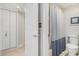 Bathroom with tiled floors, a toilet, and a shower with a blue and white shower curtain at 1801 N Ocean Blvd. # Q-2, North Myrtle Beach, SC 29582
