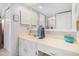 Bathroom featuring a cultured marble vanity with a framed mirror and white cabinets at 1801 N Ocean Blvd. # Q-2, North Myrtle Beach, SC 29582