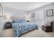 Bright bedroom featuring a blue seashell-themed bed set and gray nightstands with stylish lamps at 1801 N Ocean Blvd. # Q-2, North Myrtle Beach, SC 29582