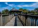 Scenic wooden walkway leading to a covered gazebo with views of the water and landscaping at 1801 N Ocean Blvd. # Q-2, North Myrtle Beach, SC 29582