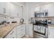 Bright kitchen features white cabinets, granite countertops, and stainless steel appliances at 1801 N Ocean Blvd. # Q-2, North Myrtle Beach, SC 29582