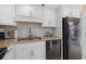 This cozy kitchen features granite countertops, white cabinets and modern, stainless steel appliances at 1801 N Ocean Blvd. # Q-2, North Myrtle Beach, SC 29582