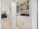 Hallway with a laundry closet featuring a washer, dryer, and shelving for storage at 1801 N Ocean Blvd. # Q-2, North Myrtle Beach, SC 29582