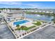 An aerial view of the community pool and hot tub surrounded by a white fence and lounge chairs overlooking a serene lake at 1801 N Ocean Blvd. # Q-2, North Myrtle Beach, SC 29582