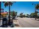 A street view with palm trees, sidewalks, colorful buildings, and street lights on a sunny day at 1801 N Ocean Blvd. # Q-2, North Myrtle Beach, SC 29582