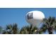 The North Myrtle Beach water tower stands tall behind lush tropical palm trees under a clear sky at 1801 N Ocean Blvd. # Q-2, North Myrtle Beach, SC 29582