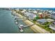 Aerial view of waterfront homes, including one with a pier, beach access, and lovely landscaping at 1924 Pompano Dr., Garden City Beach, SC 29576