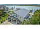 Stunning aerial view showcasing the coastal home with a metal roof, balconies, and direct waterway access at 1924 Pompano Dr., Garden City Beach, SC 29576