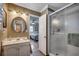 Bathroom with walk in shower, vanity with sink, and view into bedroom at 1924 Pompano Dr., Garden City Beach, SC 29576