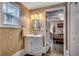 Well-lit bathroom featuring a modern vanity with storage and a decorative mirror, offering a clean and stylish space at 1924 Pompano Dr., Garden City Beach, SC 29576