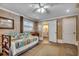 Cozy bedroom featuring tiled floors, ample lighting, and convenient access to an adjacent bathroom at 1924 Pompano Dr., Garden City Beach, SC 29576