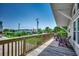 Relax on the spacious deck with wood floors and railings, featuring comfortable seating and neighborhood views at 1924 Pompano Dr., Garden City Beach, SC 29576