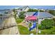 Charming waterfront home featuring a screened porch and an American flag on a sunny day at 1924 Pompano Dr., Garden City Beach, SC 29576