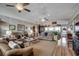 Comfortable living room showcasing hardwood floors, ceiling fans, and stylish decor at 1924 Pompano Dr., Garden City Beach, SC 29576