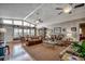 Bright and airy living room featuring hardwood floors, ceiling fans, and comfortable seating at 1924 Pompano Dr., Garden City Beach, SC 29576