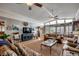 Open-concept living room featuring hardwood floors, ceiling fans, and large windows at 1924 Pompano Dr., Garden City Beach, SC 29576