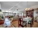 Open concept living and dining room featuring hardwood floors, ceiling fans, and plenty of seating at 1924 Pompano Dr., Garden City Beach, SC 29576
