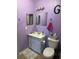 Bathroom featuring purple walls and a vanity with a white countertop and cabinet at 2005 Greens Blvd. # F-205, Myrtle Beach, SC 29577