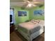 Bedroom with a comfortable bed, ceiling fan, and natural light at 2005 Greens Blvd. # F-205, Myrtle Beach, SC 29577