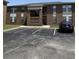 Brick building exterior with parking spaces in front on a sunny day at 2005 Greens Blvd. # F-205, Myrtle Beach, SC 29577