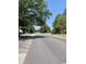 View of a street with overhead trees in a residential area at 2005 Greens Blvd. # F-205, Myrtle Beach, SC 29577