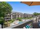 Balcony overlooking community pool, with lush landscaping, and views of the multi-story condo community at 202 Maison Dr. # L-301, Myrtle Beach, SC 29572
