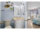 Bathroom featuring seashell decor, light blue walls and a vanity with plenty of lighting at 202 Maison Dr. # L-301, Myrtle Beach, SC 29572