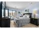 Cozy bedroom with cool toned walls, television, access to balcony and side tables with lamps at 202 Maison Dr. # L-301, Myrtle Beach, SC 29572