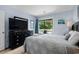 Charming bedroom featuring light blue walls, TV, balcony access and comfortable bedding at 202 Maison Dr. # L-301, Myrtle Beach, SC 29572