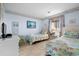 Inviting bedroom with two twin beds, beach-themed decor, TV, and bright natural light at 202 Maison Dr. # L-301, Myrtle Beach, SC 29572