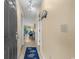 Inviting hallway leading to a bright living area with a beach-themed rug and nautical decor at 202 Maison Dr. # L-301, Myrtle Beach, SC 29572