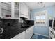 Efficient kitchen with stainless sink, granite countertops, white cabinets, and ample storage at 202 Maison Dr. # L-301, Myrtle Beach, SC 29572