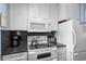 Bright kitchen with white cabinets, stone countertops, and modern stainless appliances at 202 Maison Dr. # L-301, Myrtle Beach, SC 29572