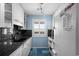 Galley kitchen with granite counters, white cabinets, and stainless appliances at 202 Maison Dr. # L-301, Myrtle Beach, SC 29572
