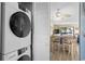 Convenient laundry area with a stacked washer and dryer and an open view to the dining area at 202 Maison Dr. # L-301, Myrtle Beach, SC 29572