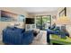 Comfortable living room featuring plush seating, large TV, and sliding glass doors to the balcony at 202 Maison Dr. # L-301, Myrtle Beach, SC 29572
