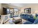 Comfortable living room featuring plush seating, large TV, and sliding glass doors to the balcony at 202 Maison Dr. # L-301, Myrtle Beach, SC 29572