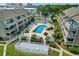 Aerial view of a condo complex pool with seating, lush landscaping, and community amenities at 202 Maison Dr. # L-301, Myrtle Beach, SC 29572